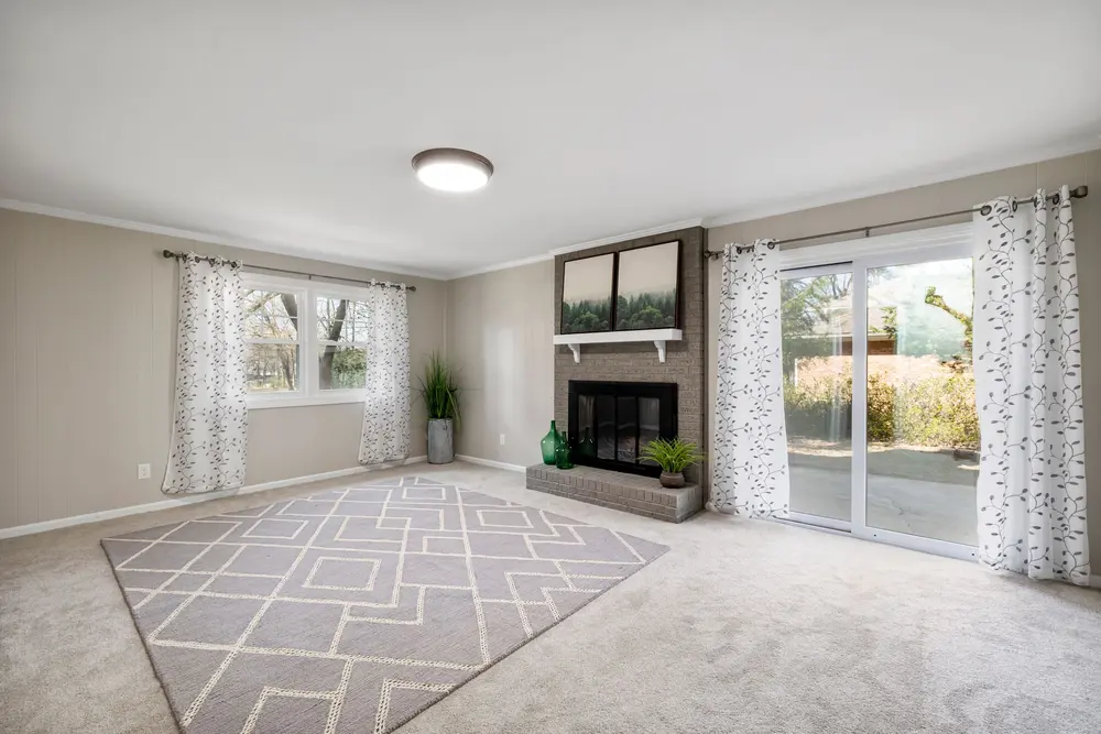 Carpet — bright spacious living room fireplace