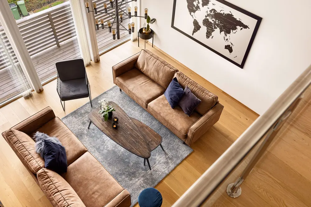 Hardwood flooring — aerial view modern living room brown sofas — flooring installed in Anaheim, CA
