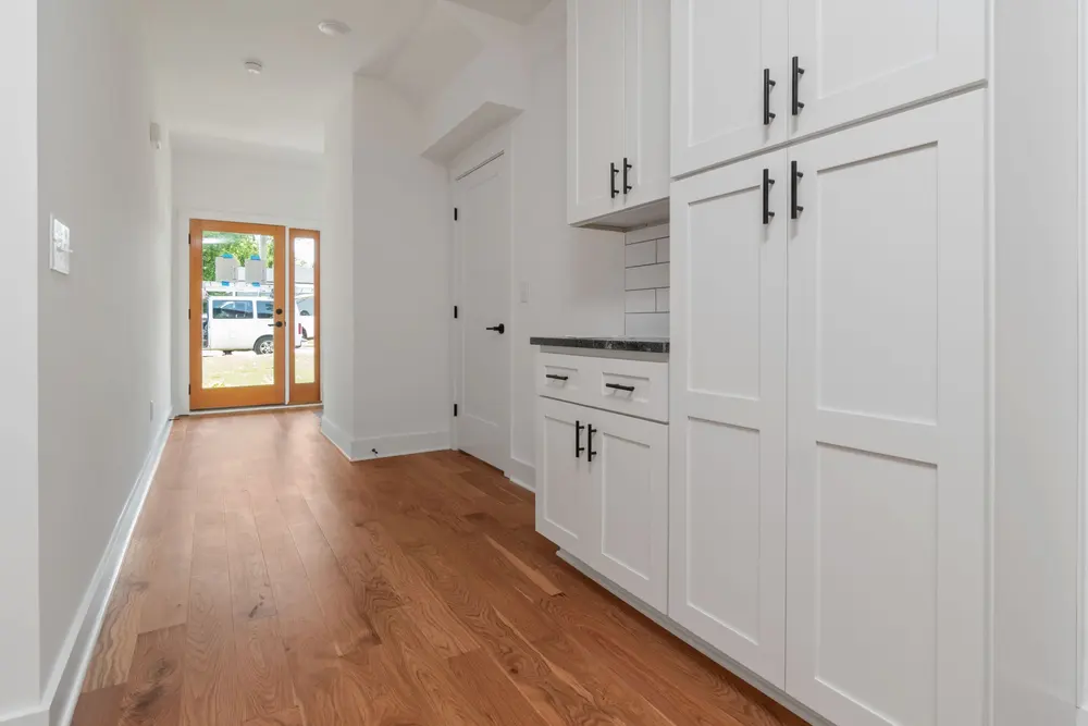 Hardwood flooring — bright clean modern kitchen white cabinets — flooring installed in Westminster, CA