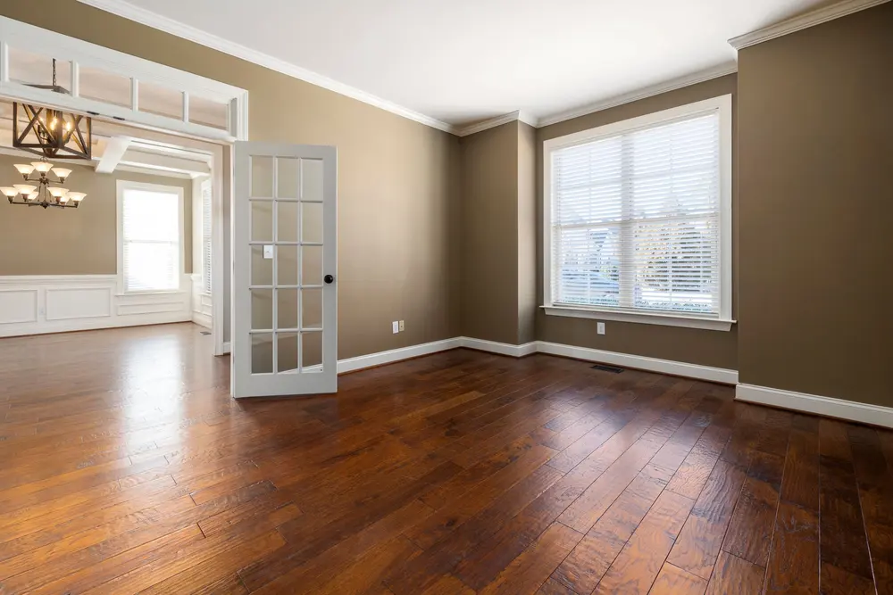 Hardwood flooring — bright empty room large windows — flooring installed in La Palma, CA