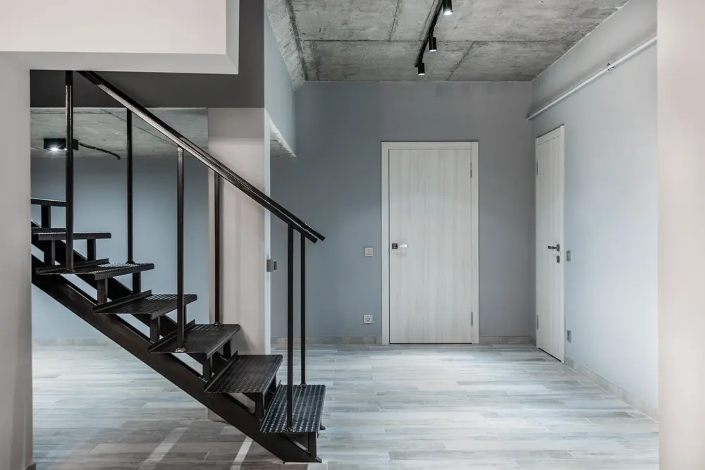 Laminate flooring — black stairway railing located corridor modern