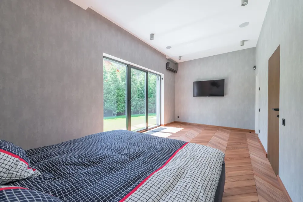 Laminate flooring — bright cozy minimalist bedroom large sliding glass