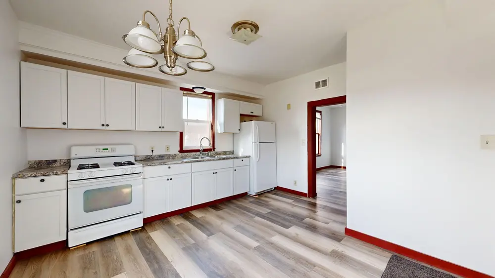 Laminate flooring — bright kitchen white cabinets
