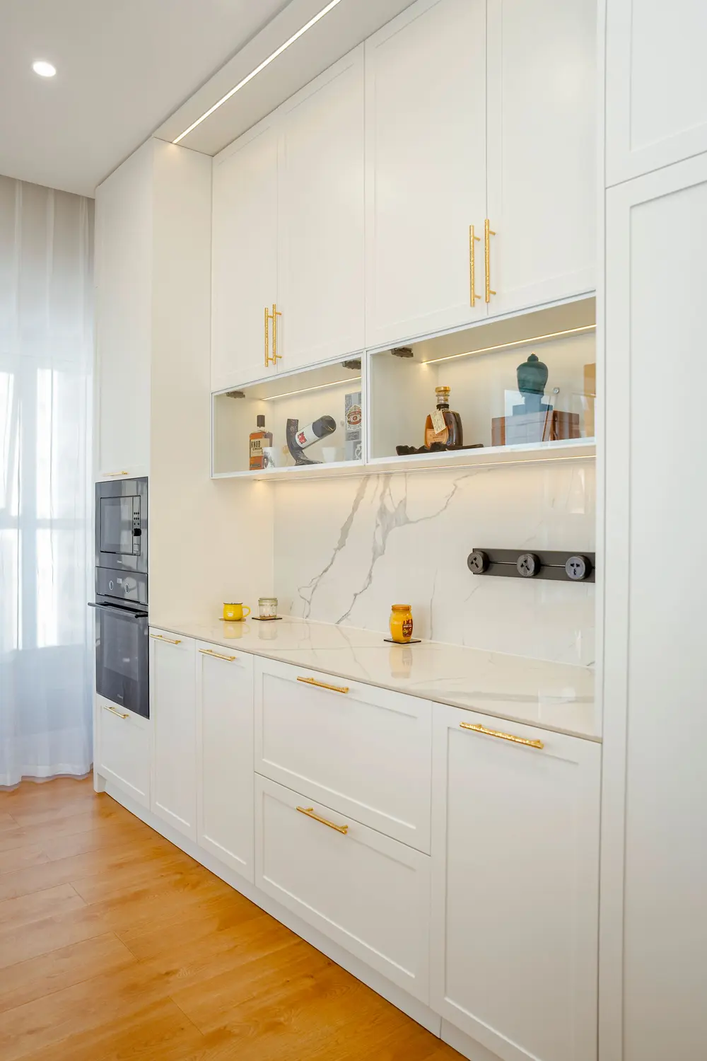 Laminate flooring — bright modern kitchen sleek white cabinets marble