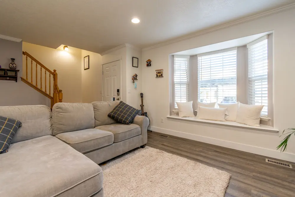 Luxury vinyl plank flooring — bright inviting living room beige sof