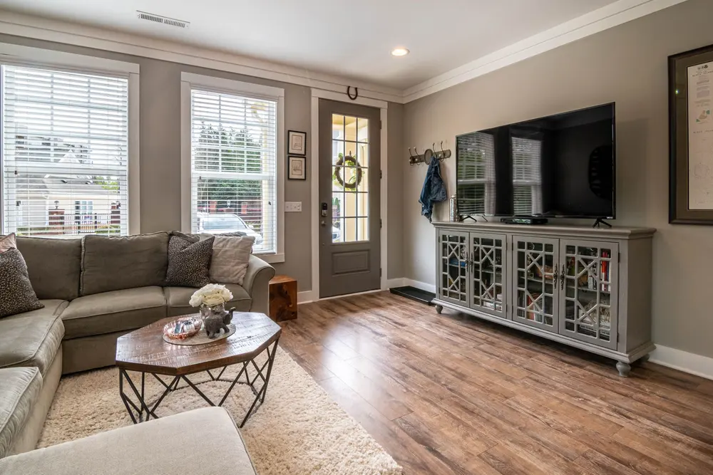 Luxury vinyl plank flooring — bright living room interior sofa t