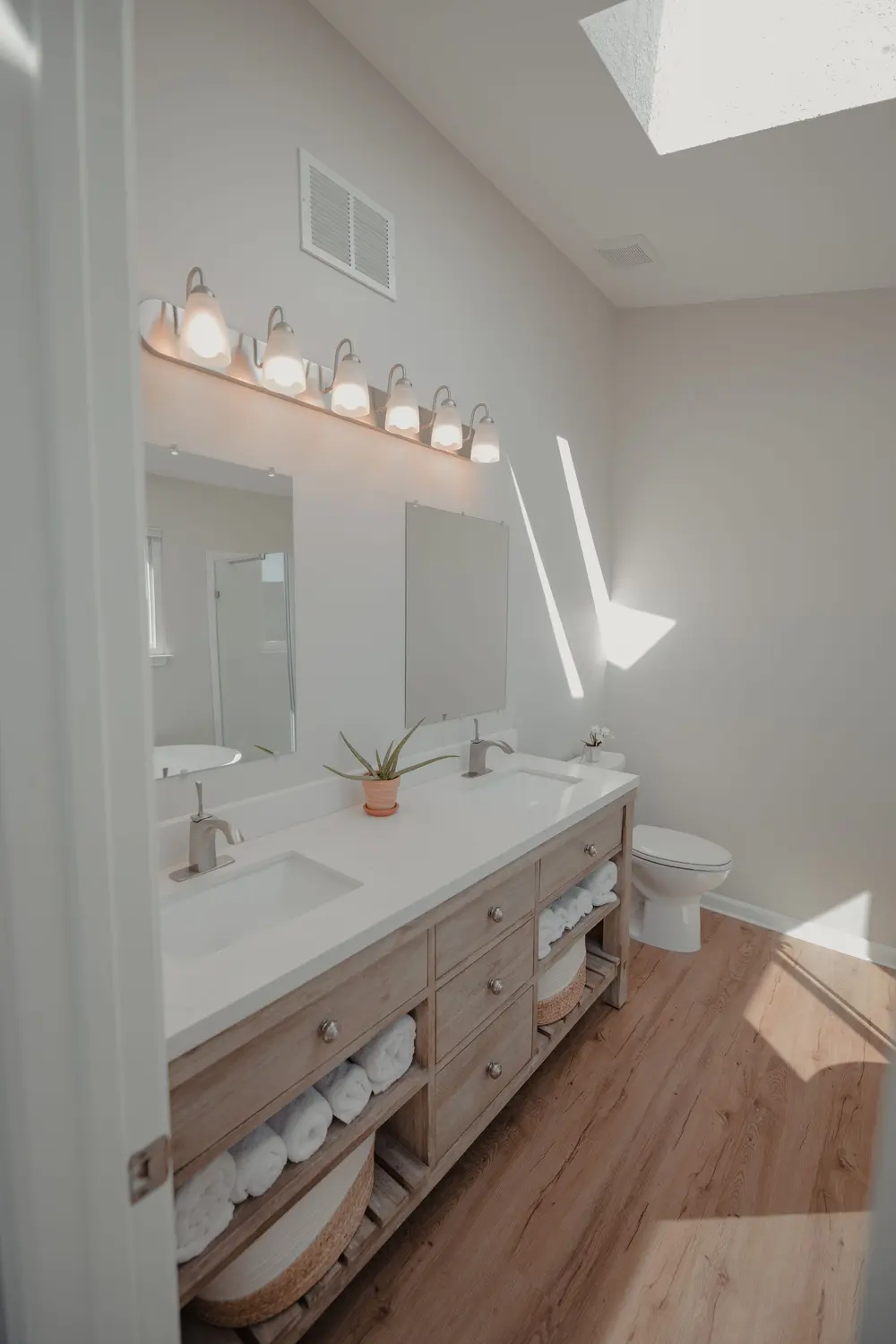 Luxury vinyl plank flooring — bright minimalist bathroom double van — near Westminster, CA