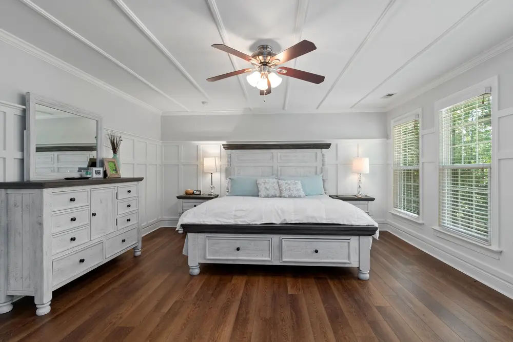 Luxury vinyl plank flooring — cozy modern bedroom white decor — near Irvine, CA