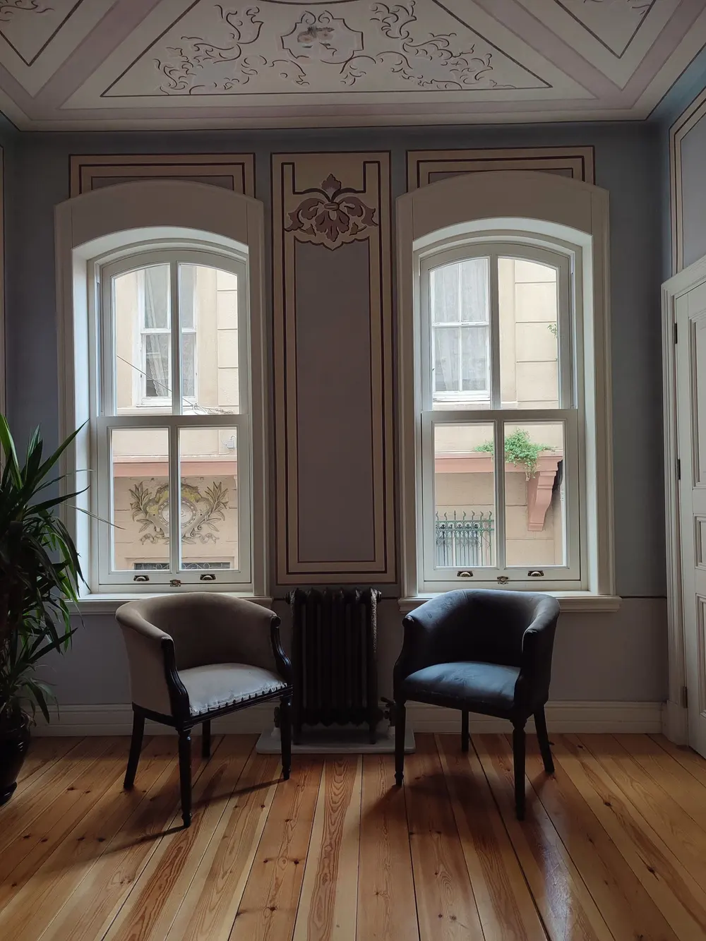Refinished hardwood flooring — cozy room two classic chairs stylish