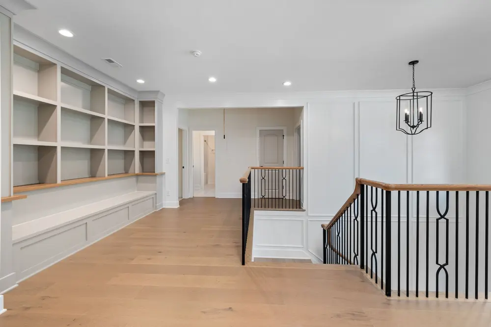 Staircase and trim work — bright modern foyer custom