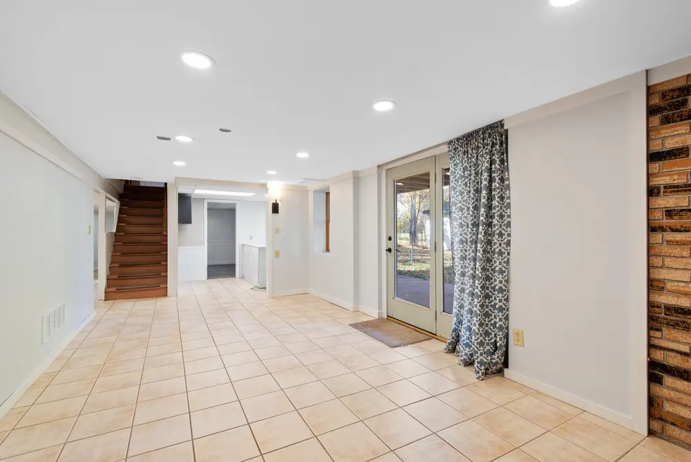 Tile flooring — bright empty basement glass doors